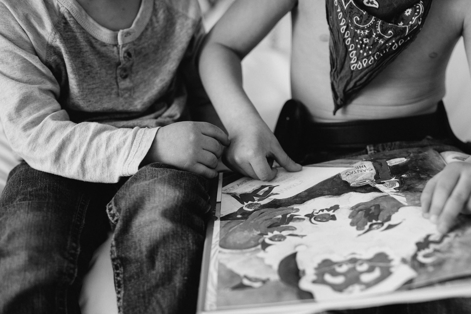 young brothers reading story together touching hands - Markham child photography