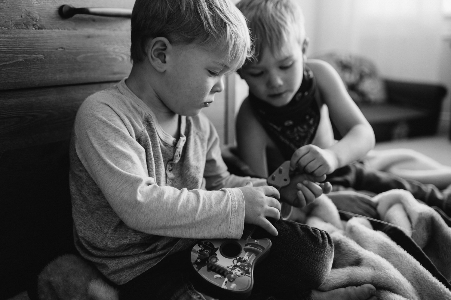 young blonde brothers playing with toy guitar - Stouffville child photography