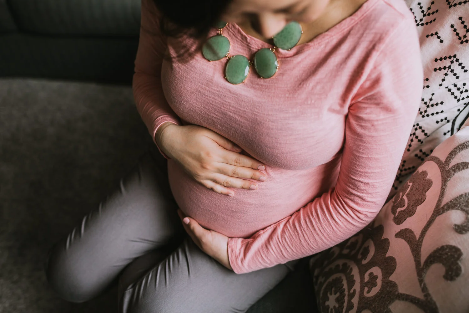pregnant mother to be holding baby bump - Newmarket in-home photography