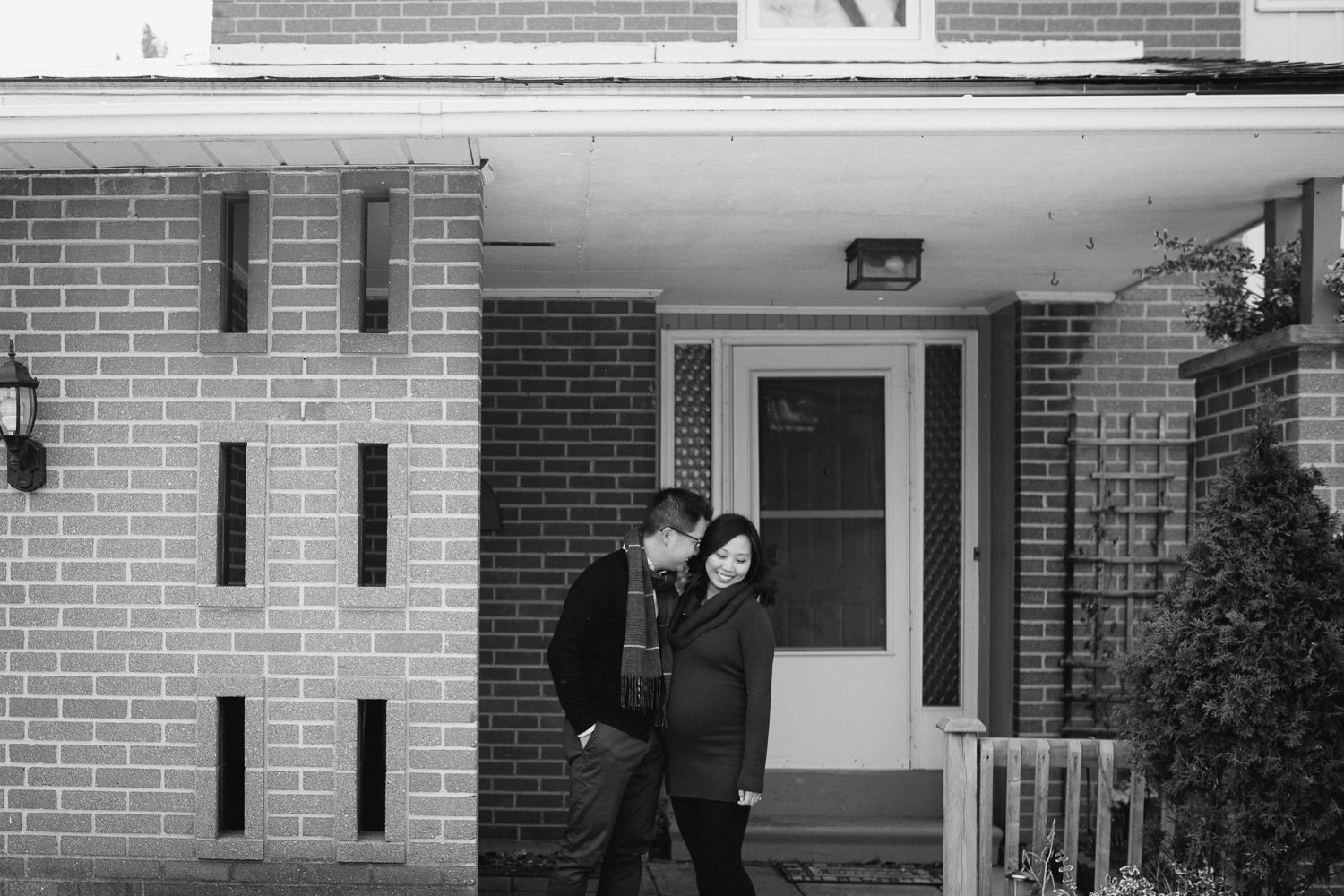 couple expecting first baby in front of first home - Markham lifestyle photography