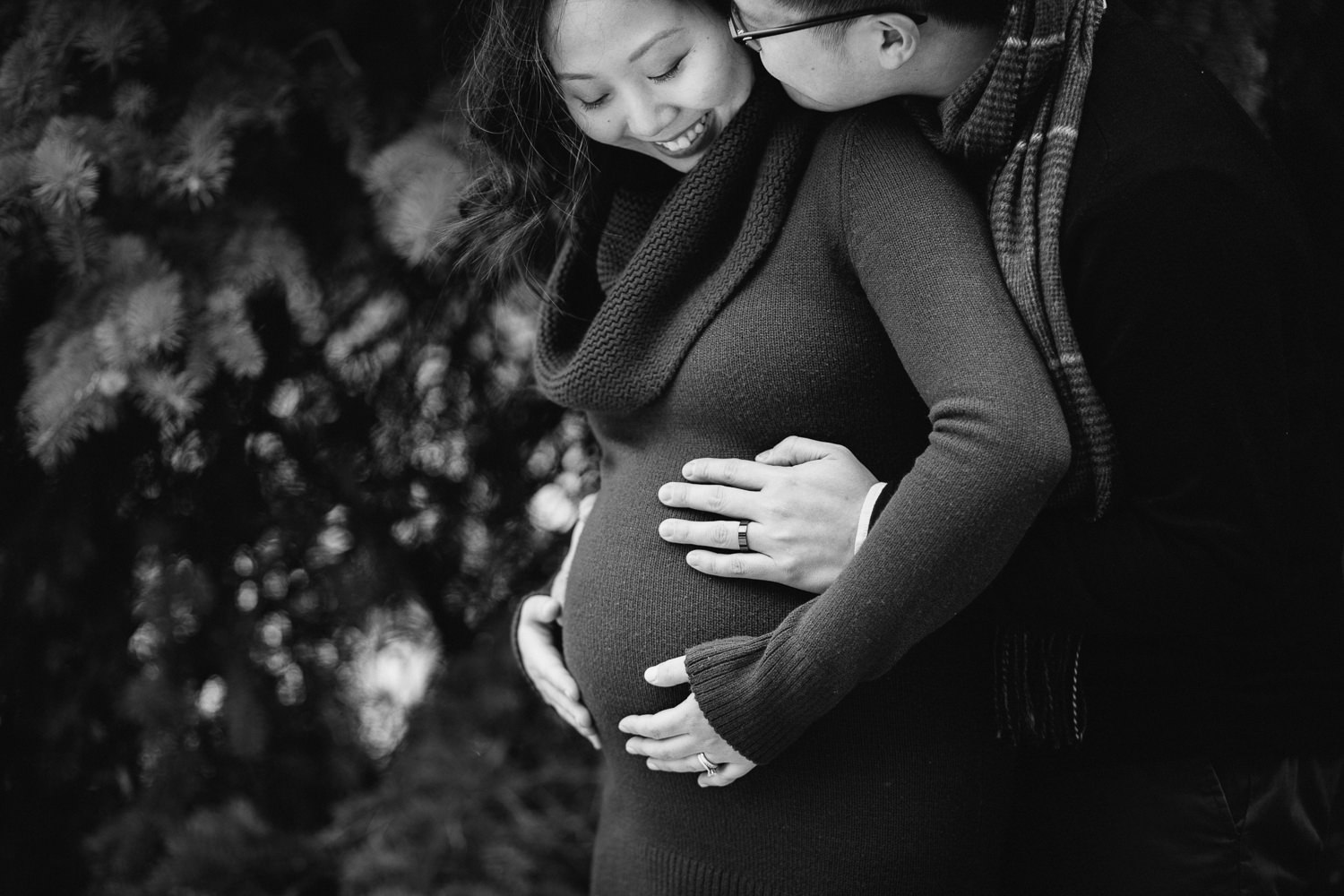 husband and wife embrace and hold woman's pregnant belly - Uxbridge lifestyle photography