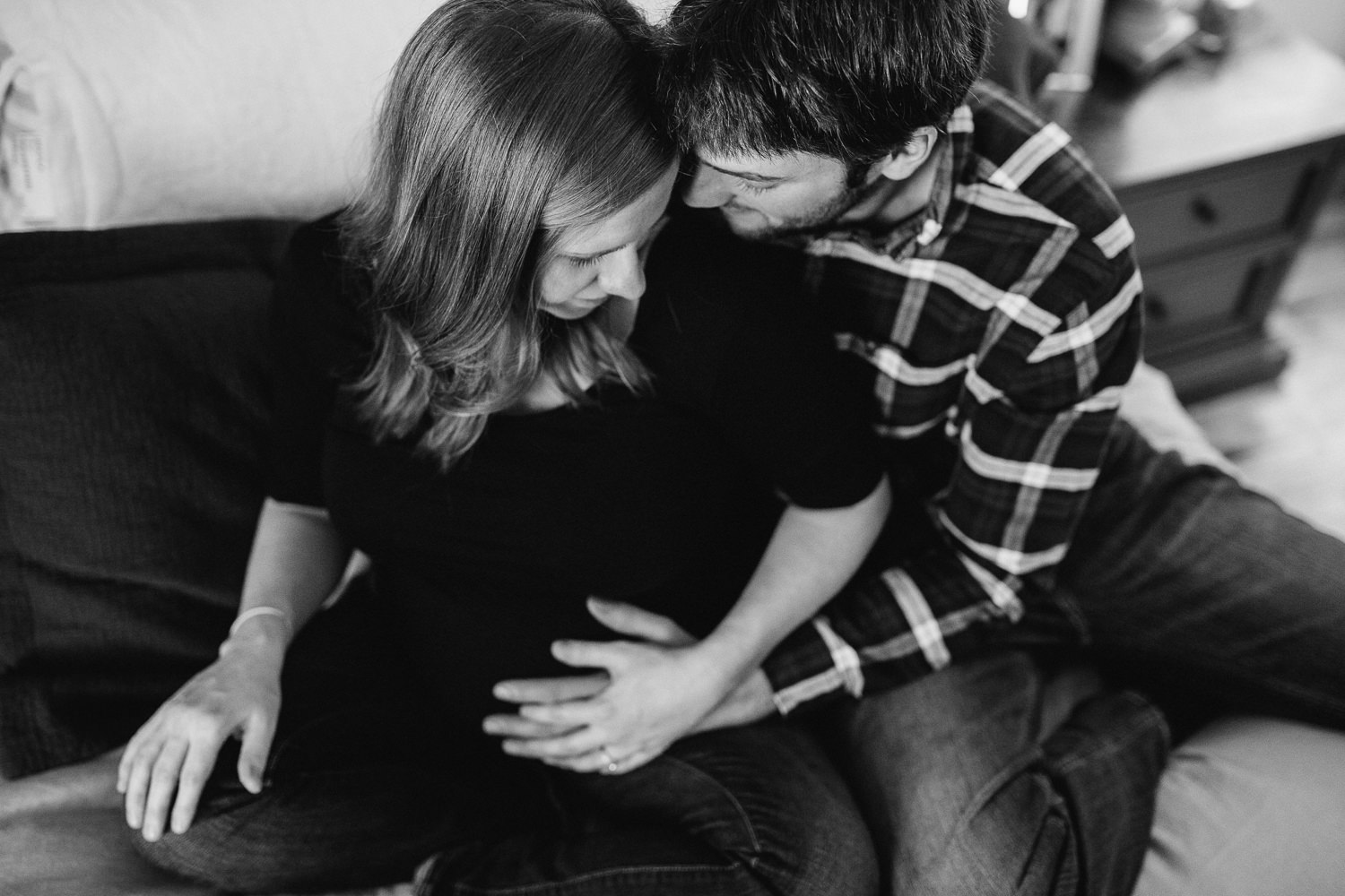 pregnant wife and husband snuggle on bed - Stouffville lifestyle photography