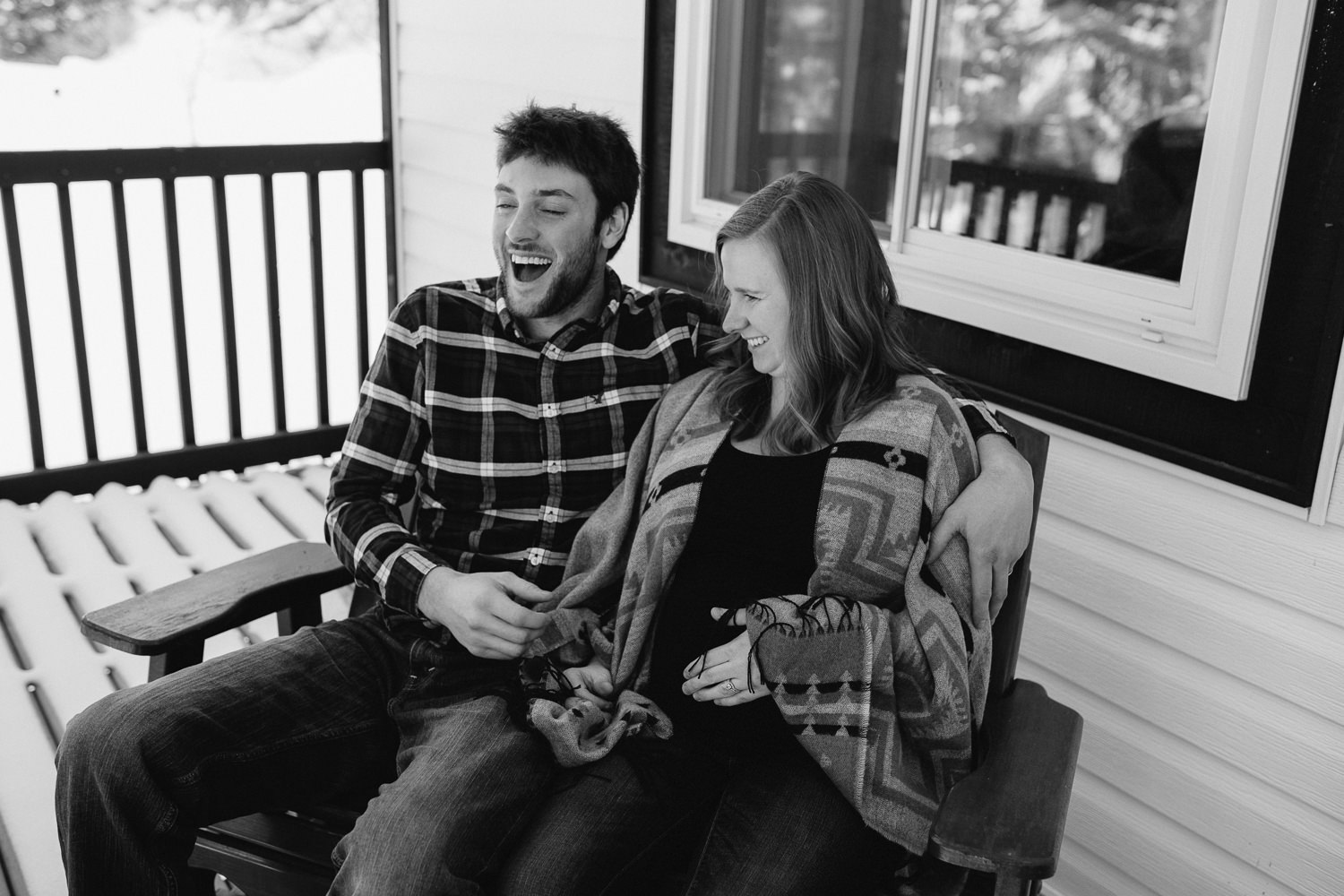 parents to be sitting on front porch laughing together - Stouffville lifestyle photography