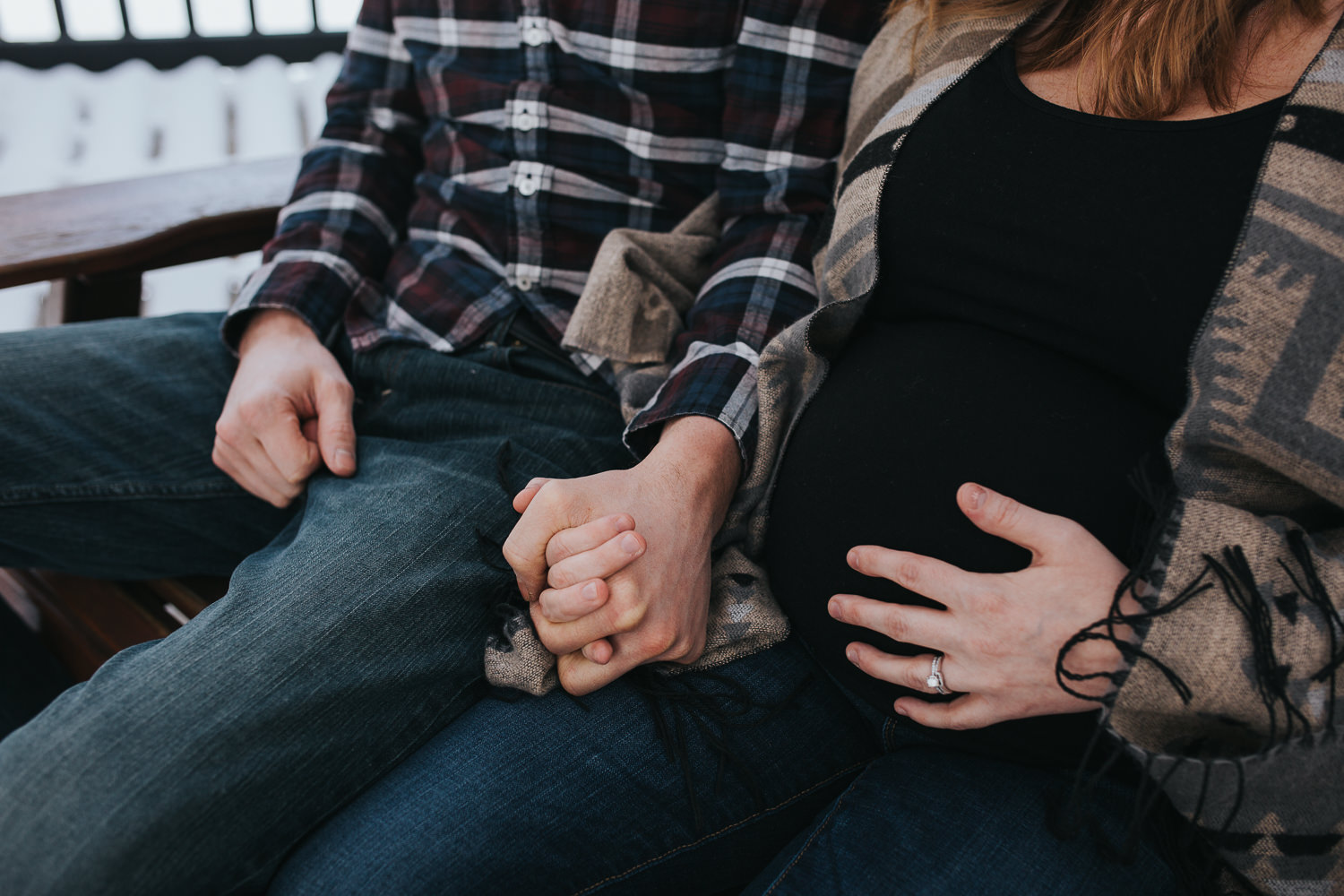 parents to be sitting on front porch holding hands, wife touching baby belly - Markham lifestyle photography
