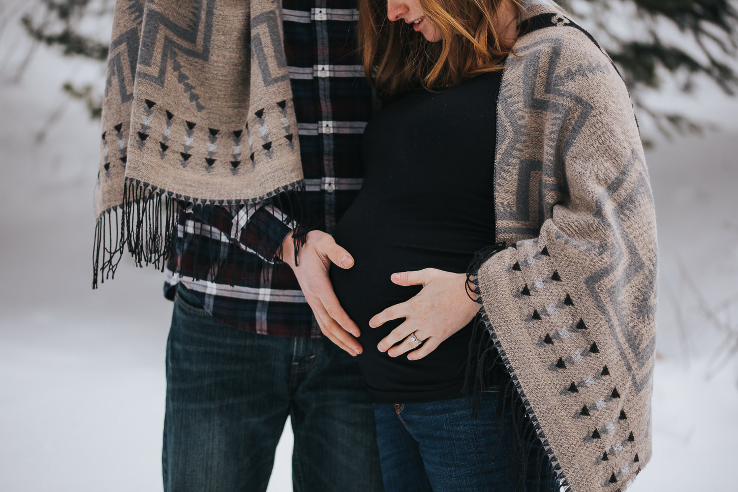 husband and wife rest hands on pregnant mom's baby bump - Markham lifestyle photos