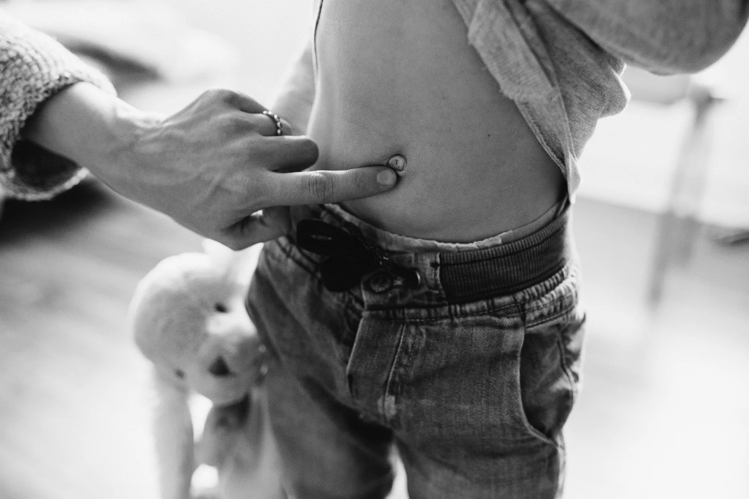 mom poking 2 year old toddler boy's belly button - uxbridge family photography
