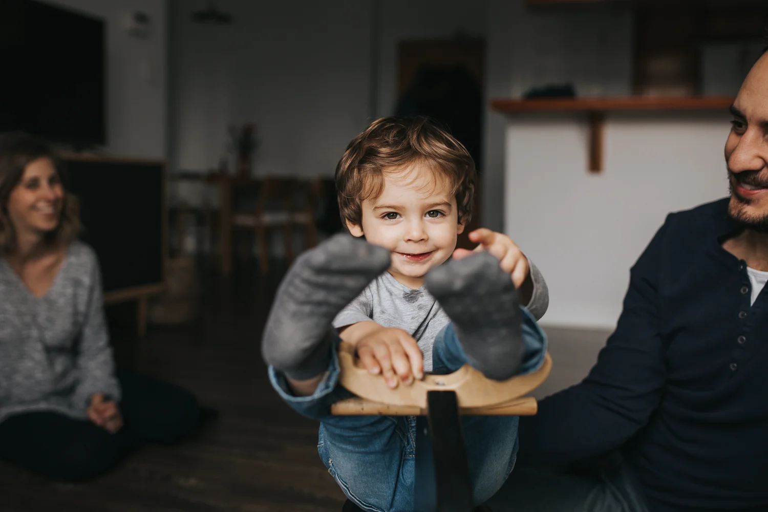 2 year old toddler boy on rocking horse, parents watching - markham in-home lifestyle photos