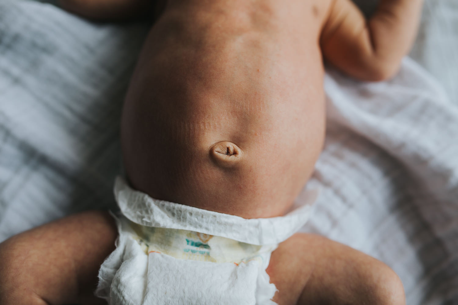 newborn baby boy lying on bed, close up of belly button - Barrie lifestyle photography