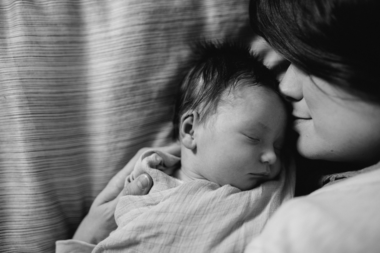 new mom snuggled face to face with 2 week old baby daughter - Barrie lifestyle photography session