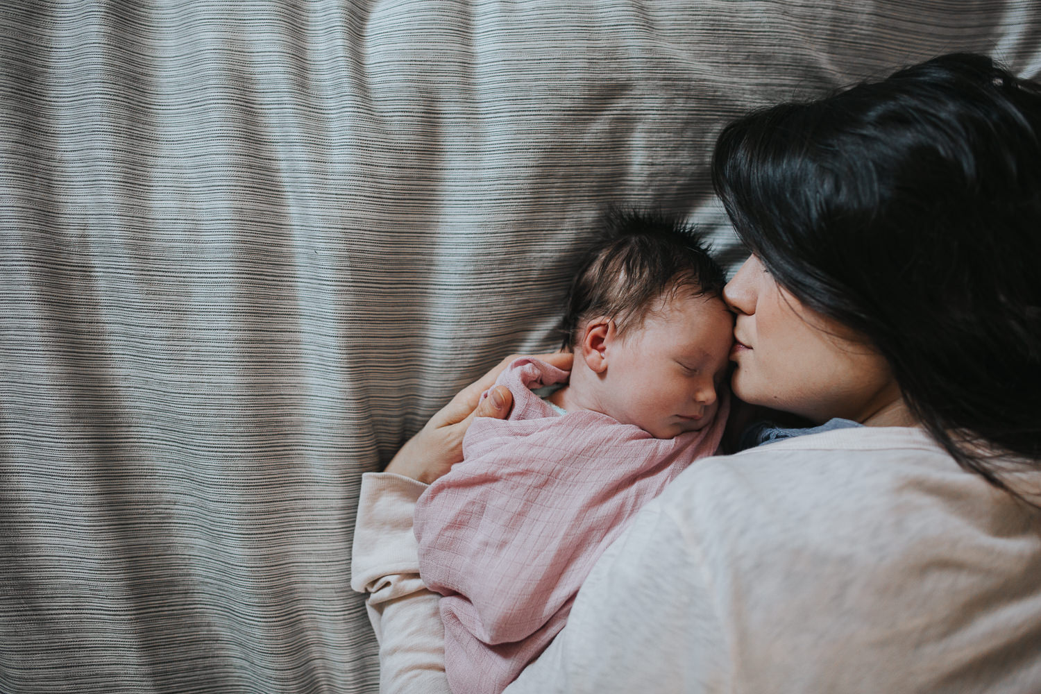 new mom snuggled face to face with 2 week old baby daughter - Barrie lifestyle photography