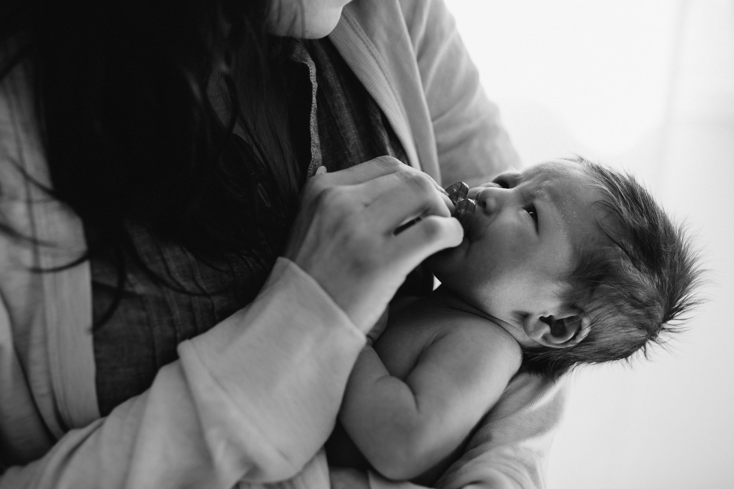 mom holding and comforting 2 week old baby daughter - Newmarket lifestyle photography 