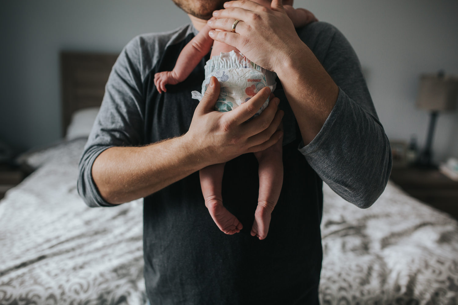 new dad holding 6 week old baby daughter - Newmarket in-home photos