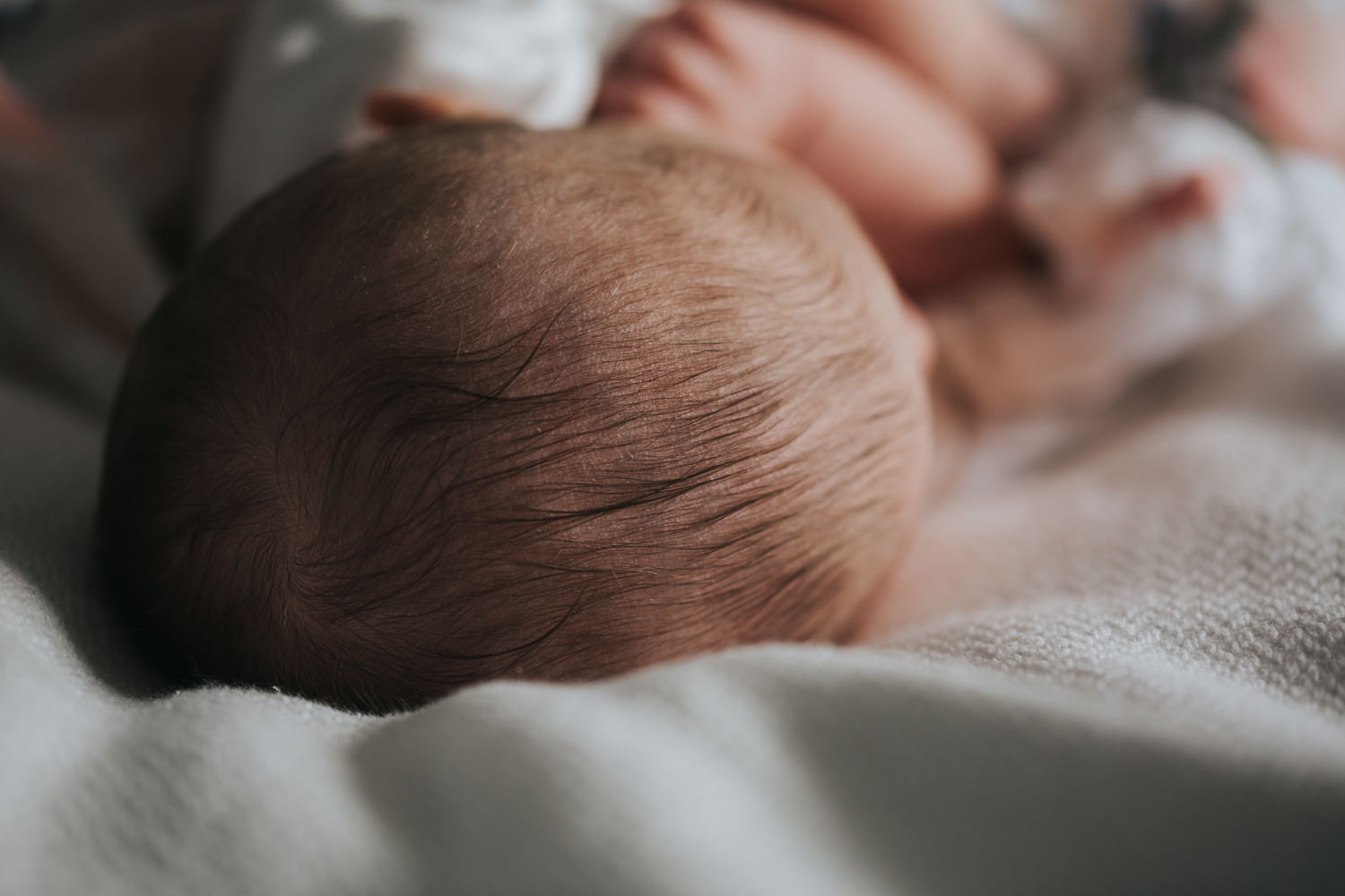 6 week old baby girl lying on bed asleep, close up of hair - Markham lifestyle photography