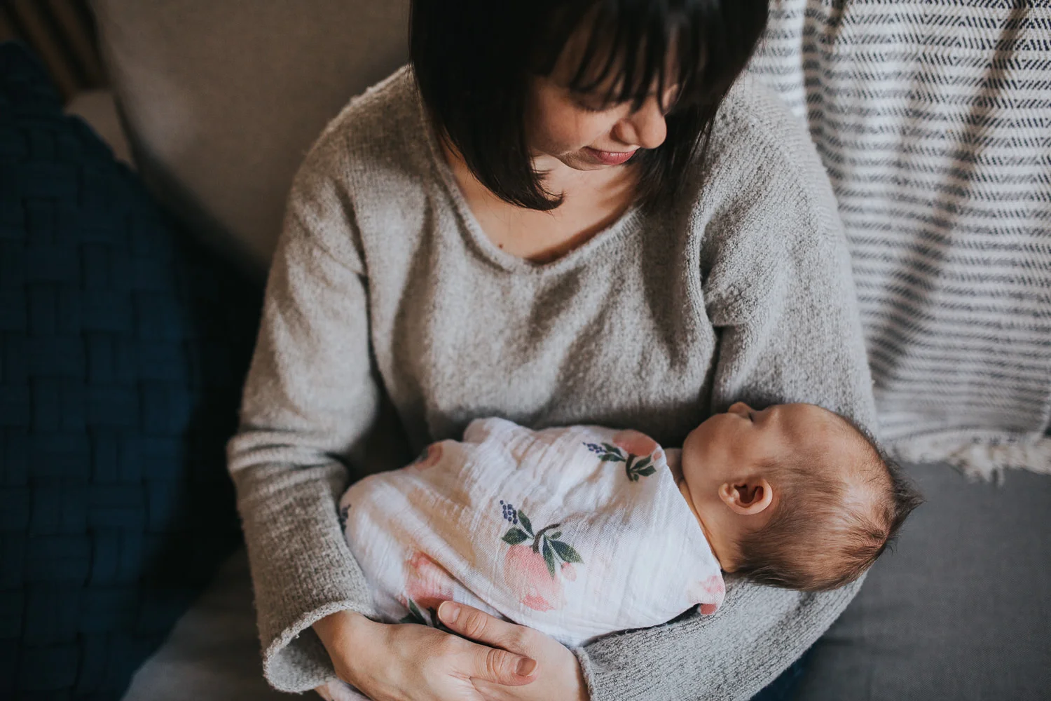 brunette mother holds 5 week old swaddled, sleeping baby girl - Newmarket lifestyle photography
