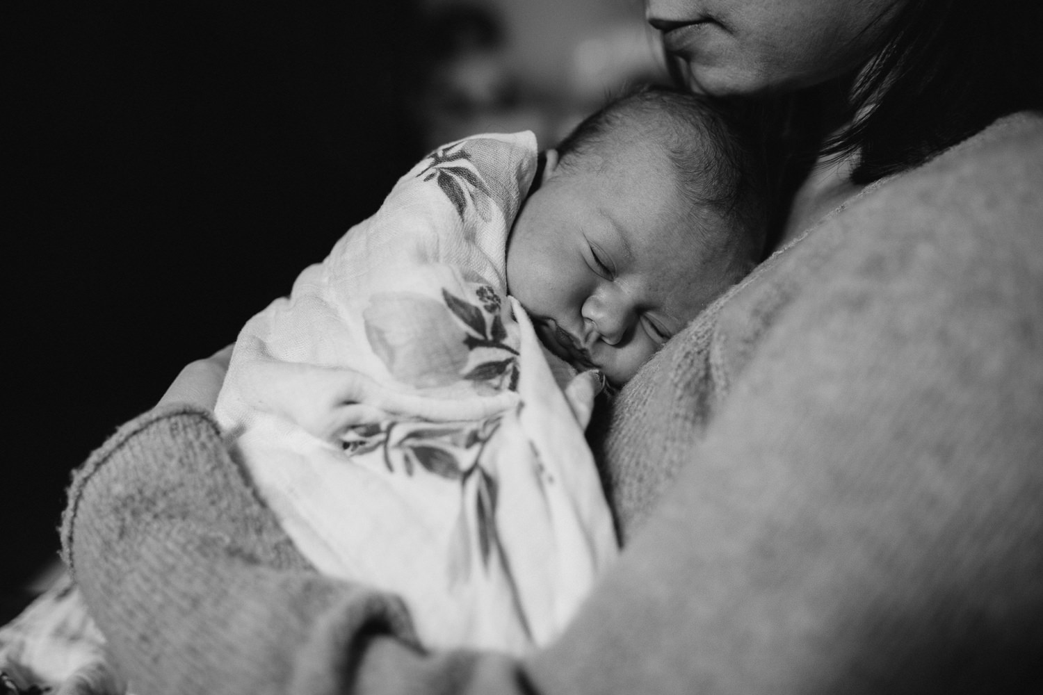 brunette mother holds 5 week old swaddled, sleeping baby girl - Barrie lifestyle photography