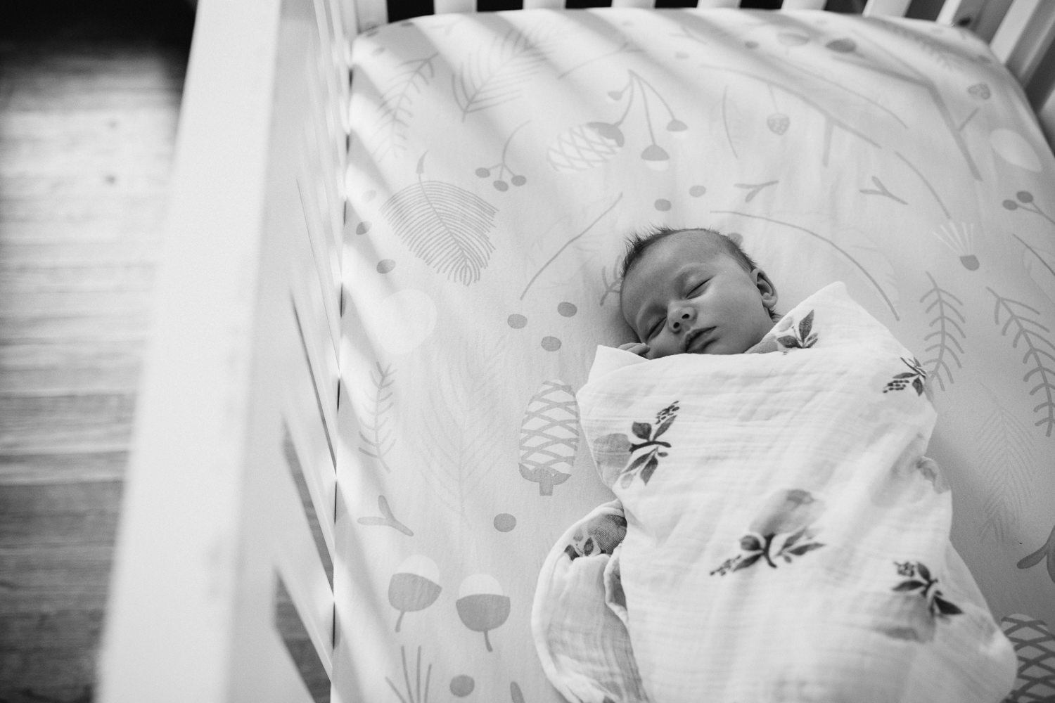 5 week old baby girl swaddled and sleeping in crib - Newmarket lifestyle photos