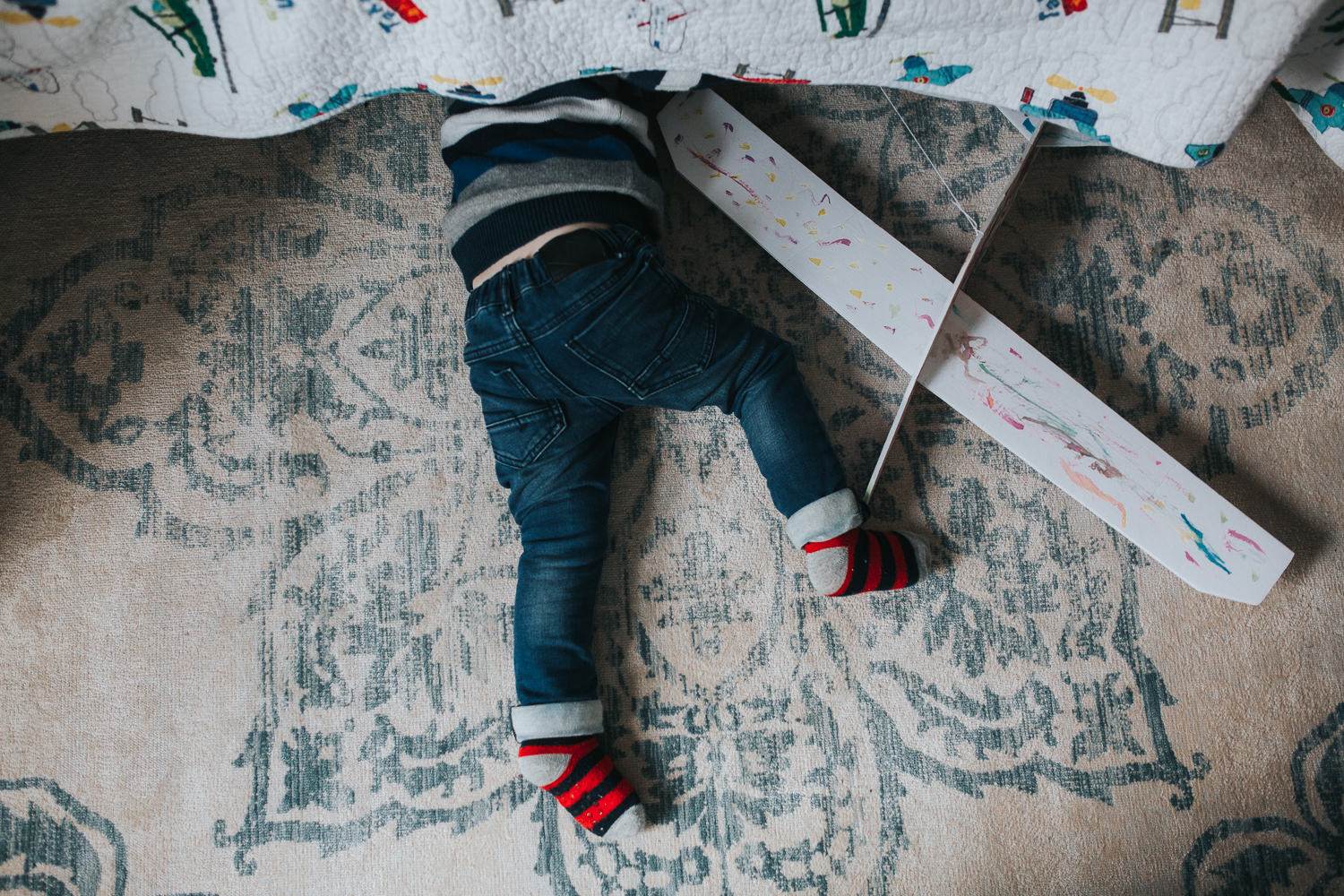 3 year old toddler boy with head under bed looking for toy - Newmarket lifestyle photography