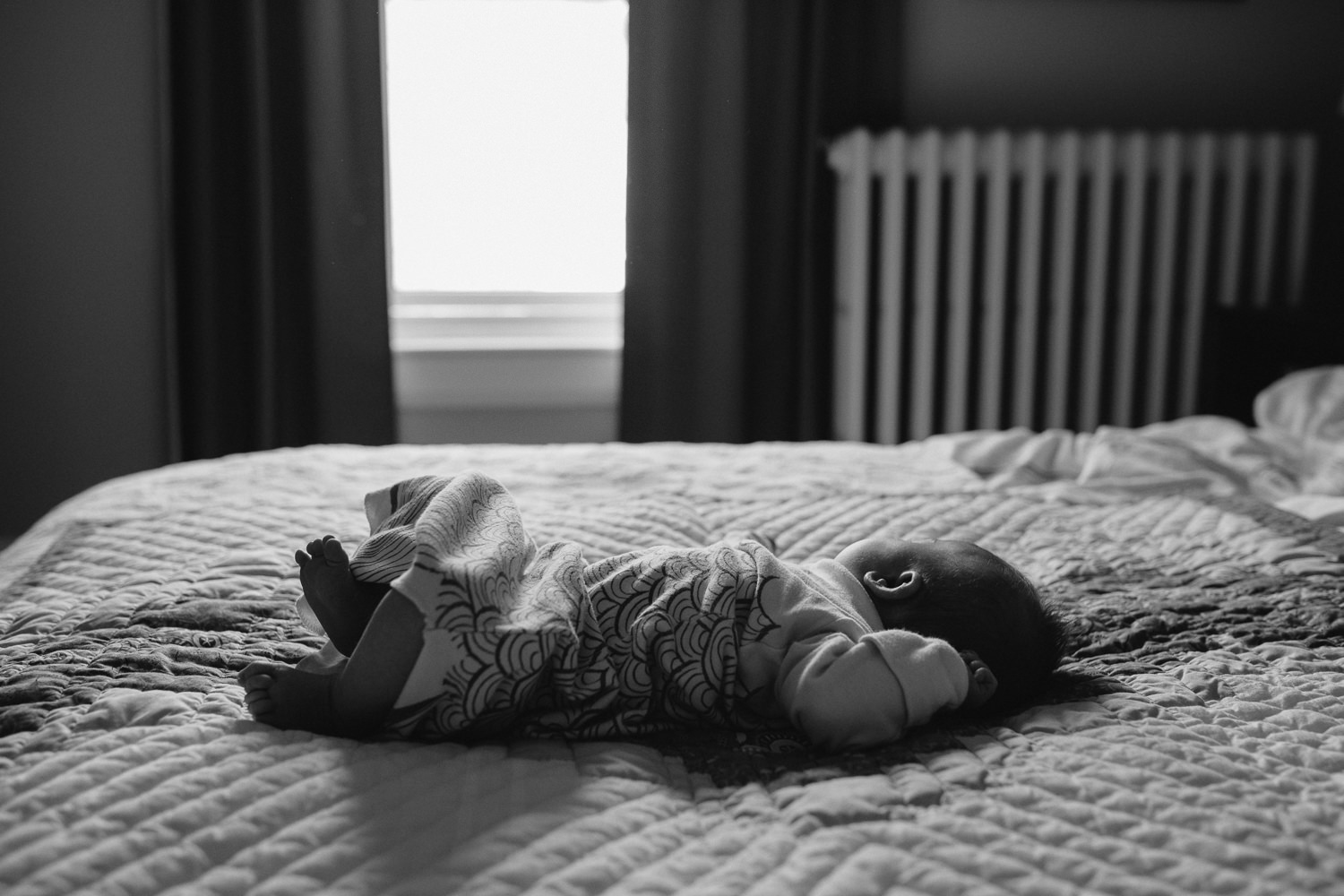 5 week old baby girl lying on parent's bed in master bedroom - Markham lifestyle photos