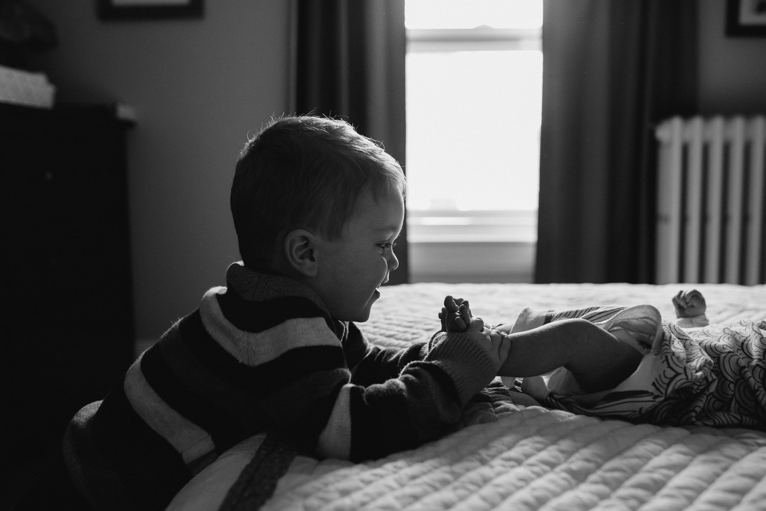 3 year old big brother playing with baby sister's feet - Barrie lifestyle photos