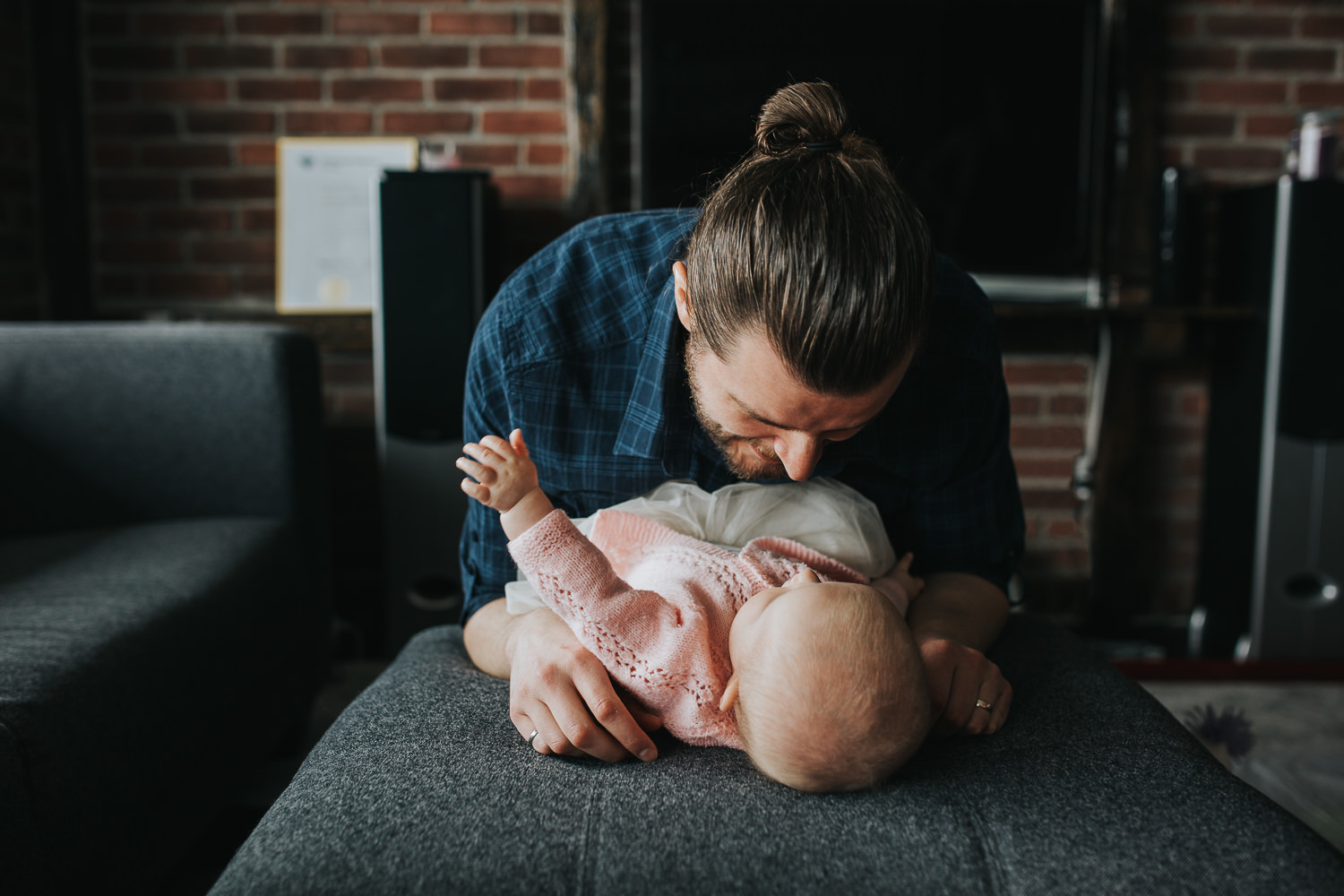 father playing with 5 month old baby daughter lying on couch - Newmarket lifestyle photography