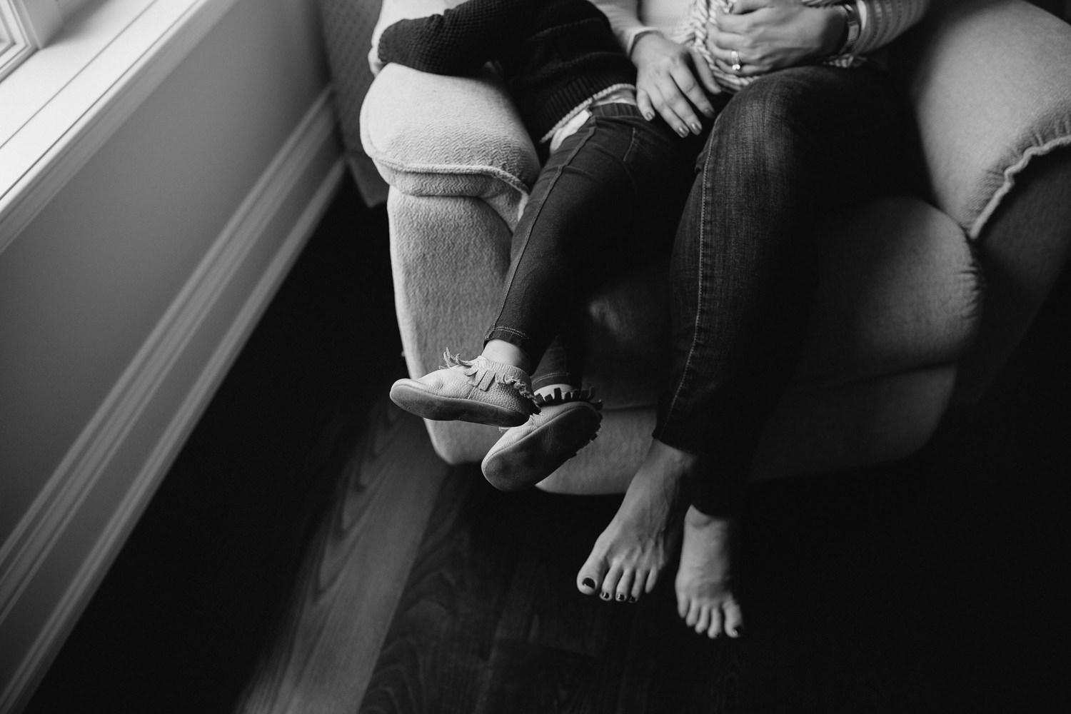 2 year old toddler girl and mother's feet, sitting in glider - Barrie in-home photography 