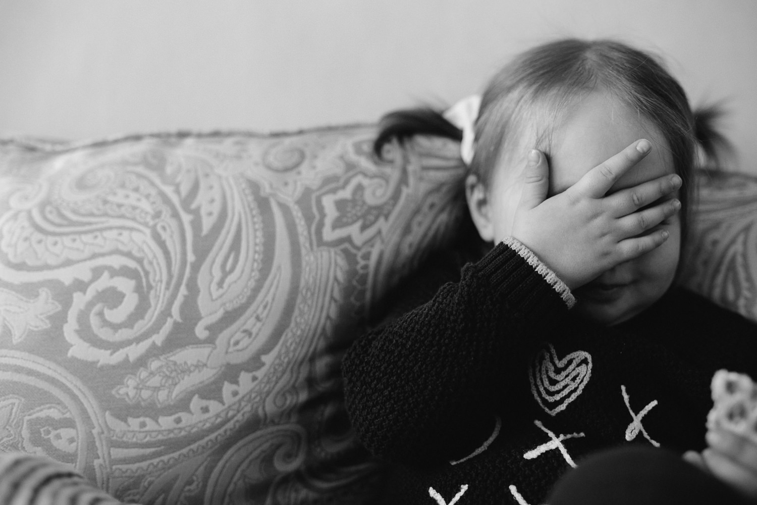 2 year old toddler girl covering face with hand - Newmarket lifestyle photography