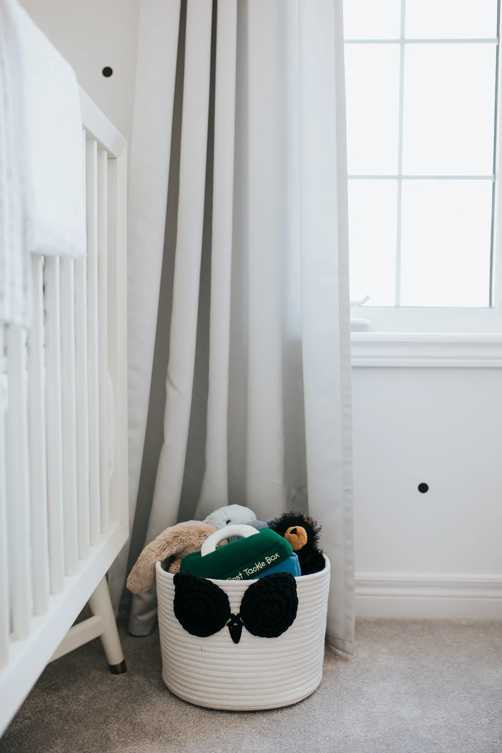 monochromatic black and white nursery details, basket of stuffed toys - Uxbridge lifestyle photos