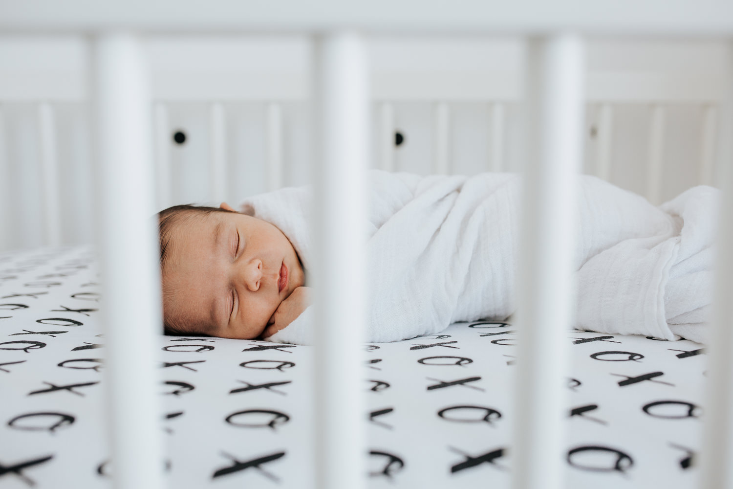 2 week old baby boy sleeping in monochromatic black and white nursery crib - Markham lifestyle photography