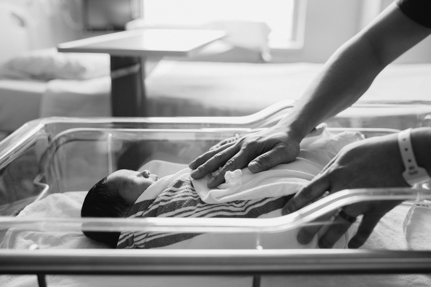 new father's hand resting on 1 day old baby son sleeping in hospital bassinet - Stouffville Fresh 48 photos