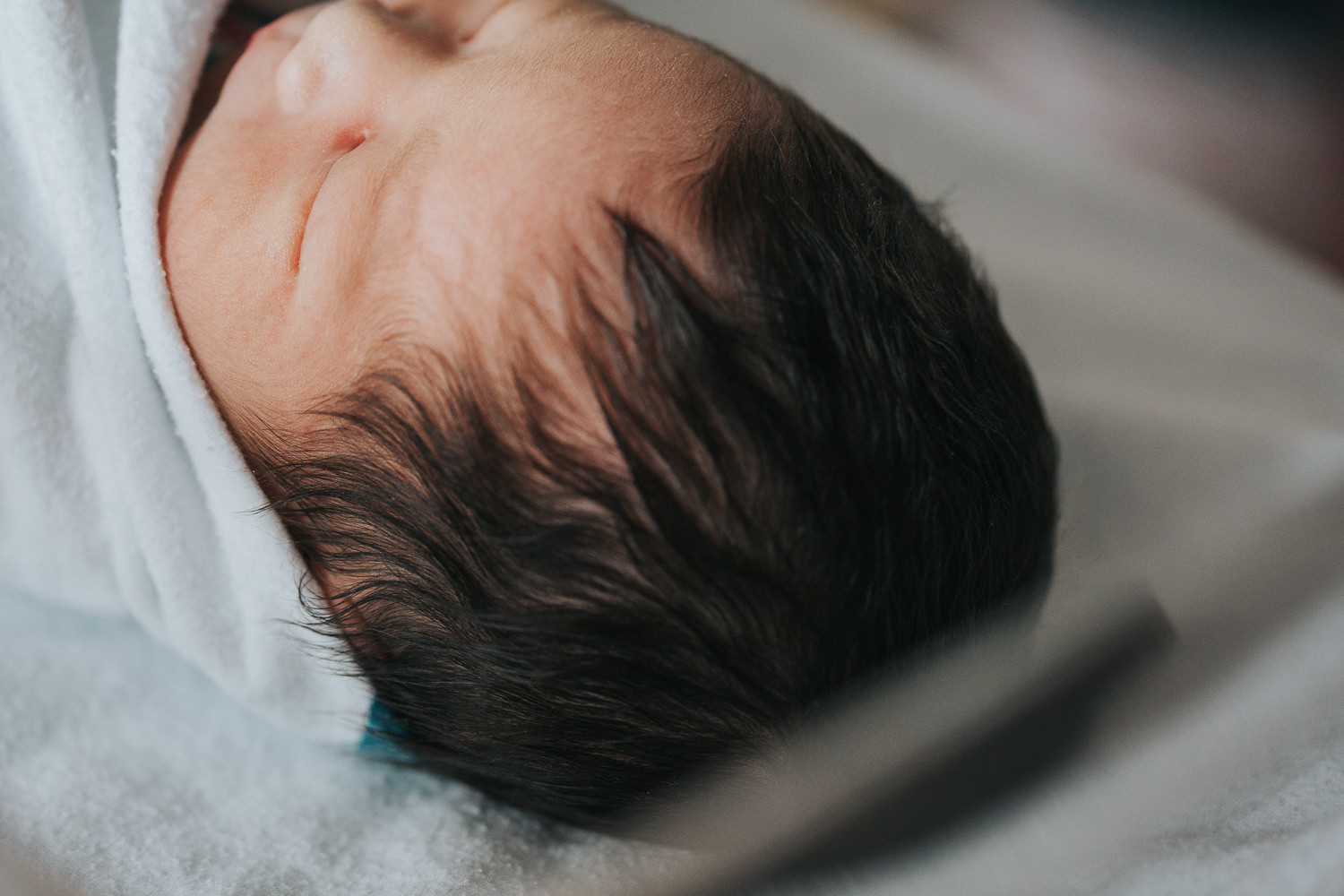 1 day old baby boy swaddled, lying in hospital bassinet, close up of dark black hair - Barrie Fresh 48 photos
