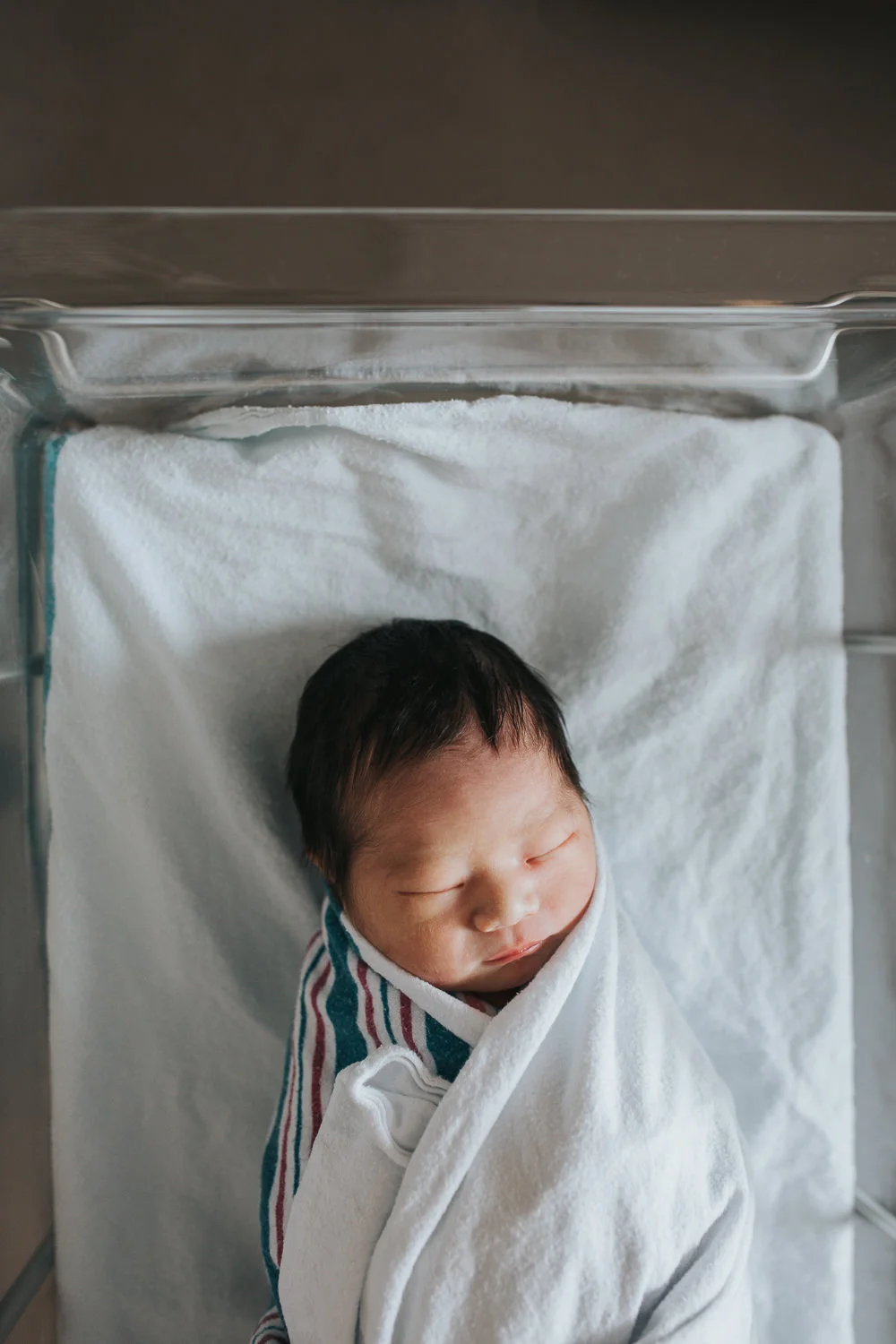 1 day old baby boy sleeping swaddled in hospital bassinet - Stouffville Fresh 48 photography