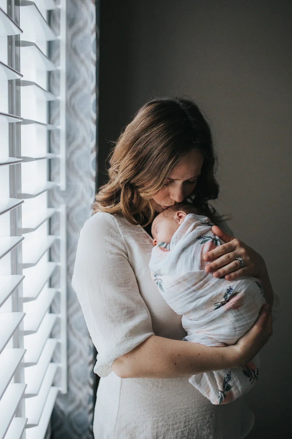 new mother snuggles sleeping, swaddled 2 week old baby daughter to chest - Stouffville Lifestyle Photography