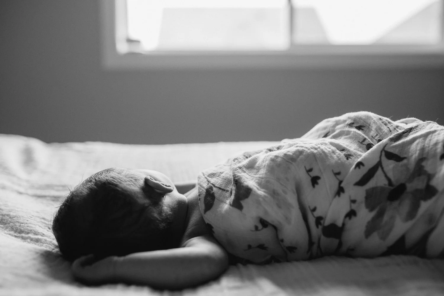 2 week old baby girl in swaddle lying asleep on bed - Markham In-Home