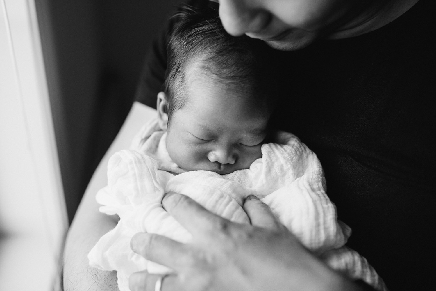 new dad holds 2 week old sleeping baby boy - Uxbridge Lifestyle Photos