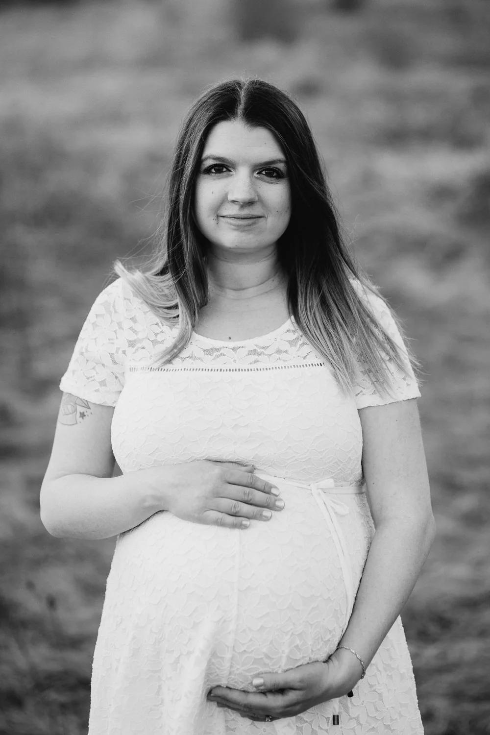 pregnant mom to be holding baby belly and looking at camera - Stouffville Lifestyle Photography