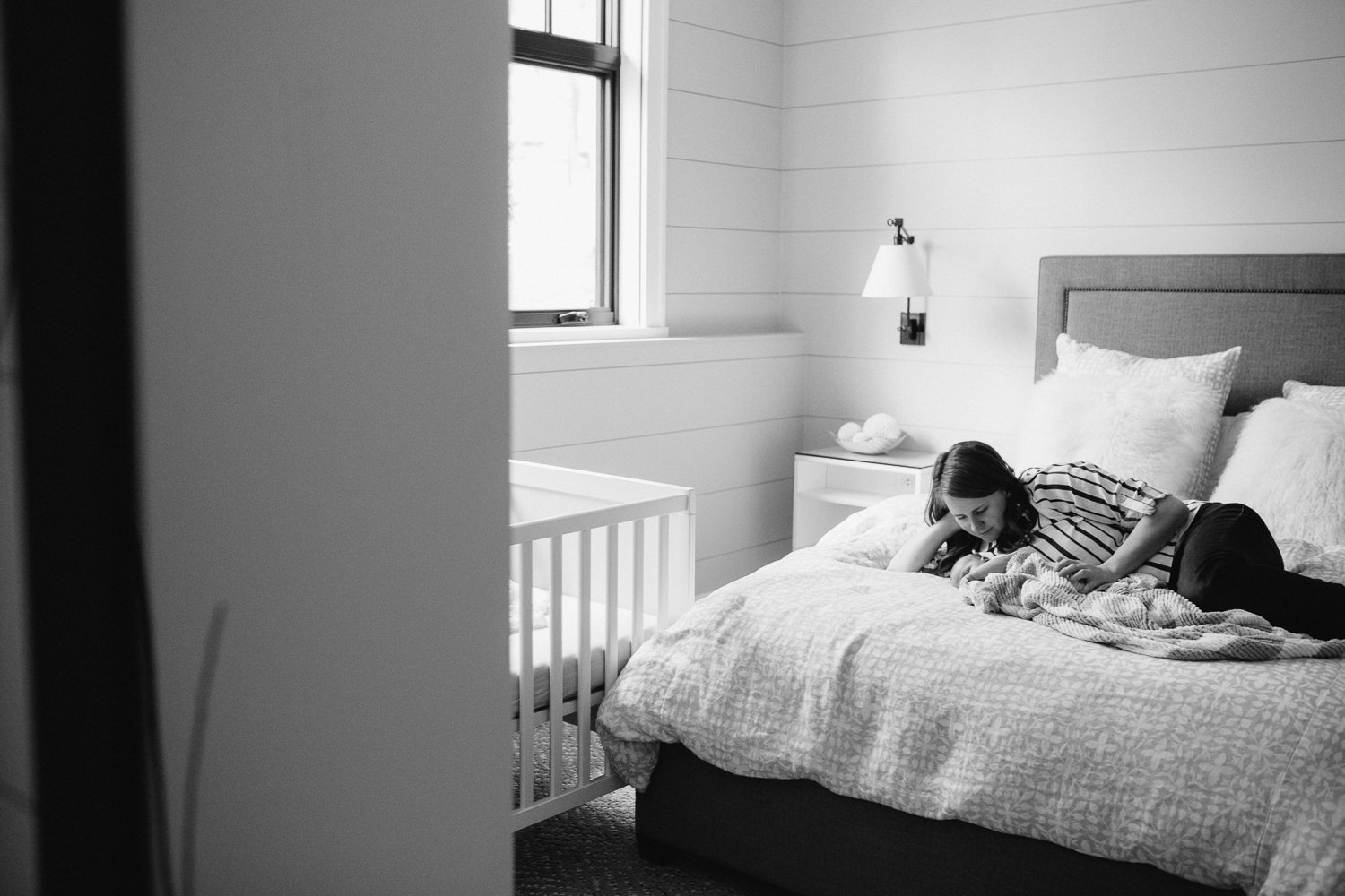 first time mom and 2 week old baby boy lying on bed, snuggling - Uxbridge Lifestyle Photography