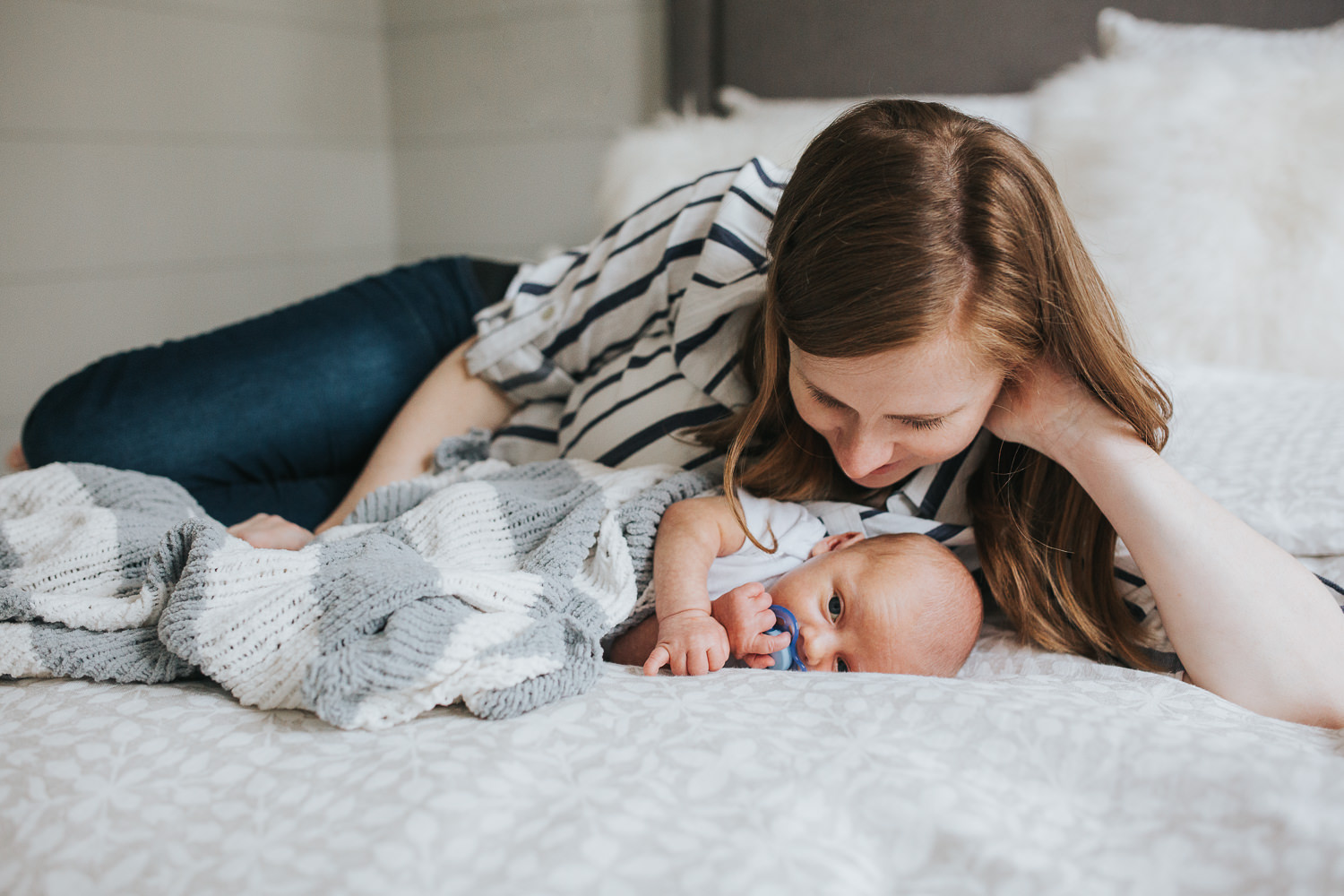 first time mom and 2 week old baby boy lying on bed - Barrie Lifestyle Photography