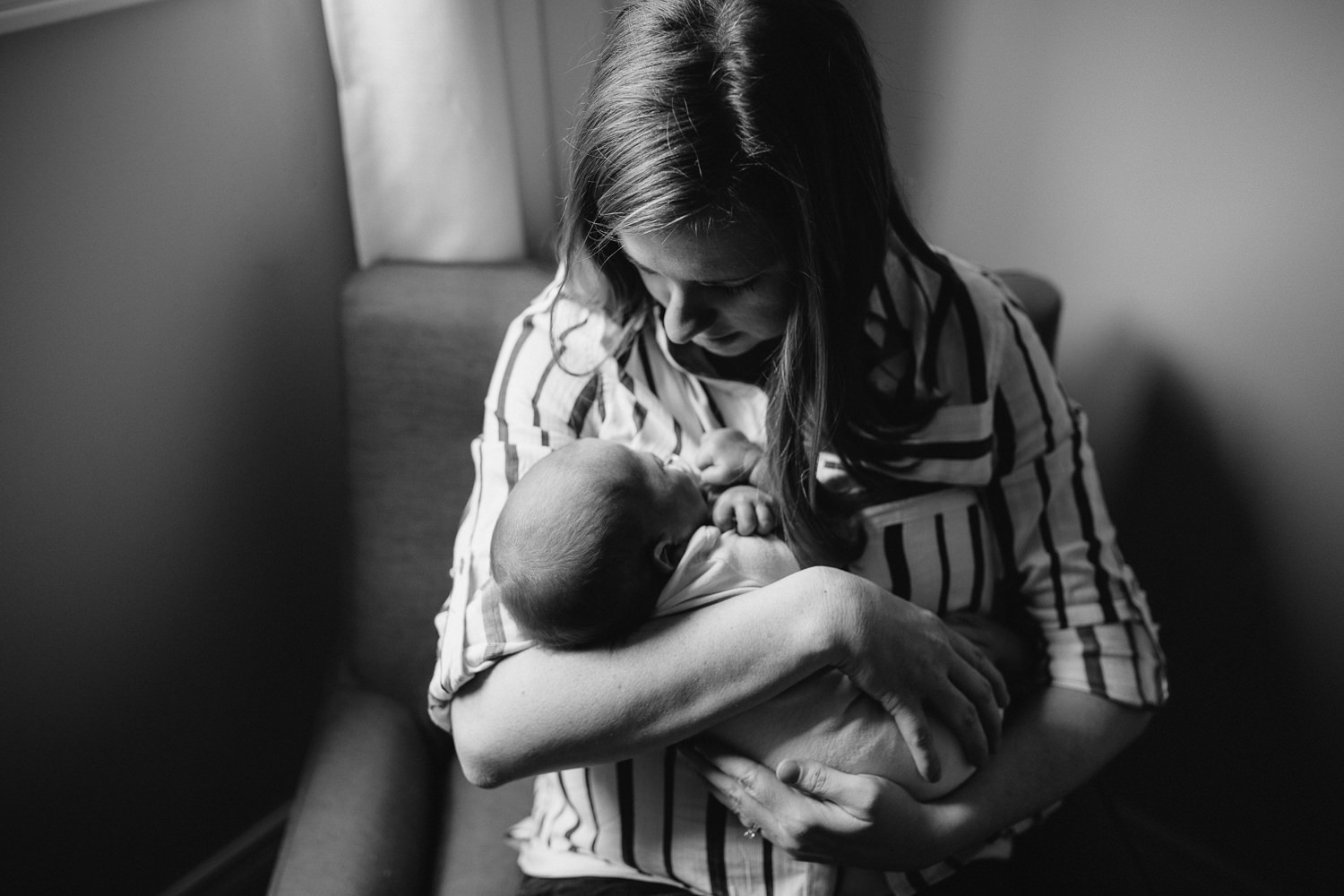 first time mother holding and looking at 2 week old baby son - Markham In-Home Photos