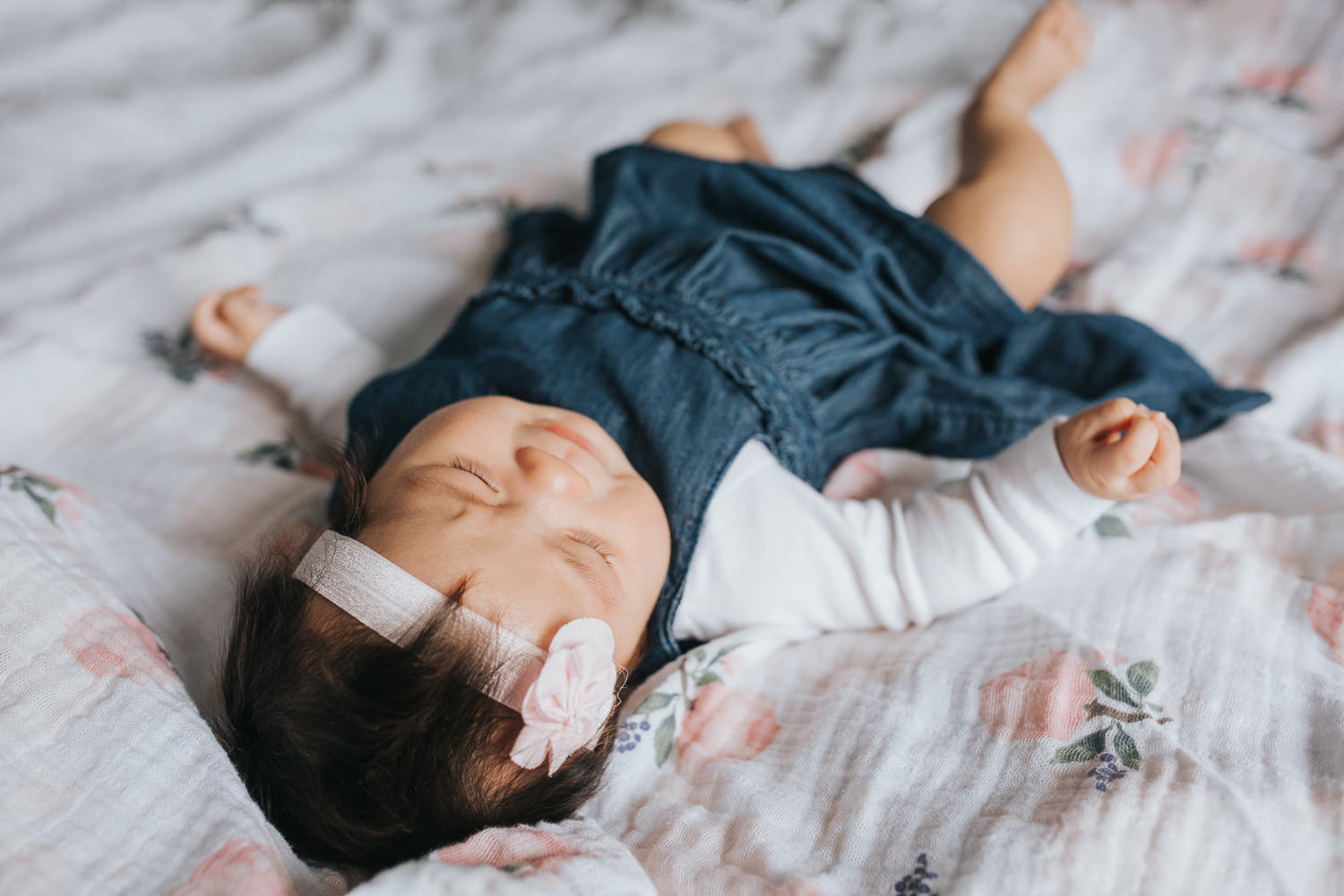 3 month old baby girl in blue dress lying on floral blanket - Barrie Lifestyle Photography