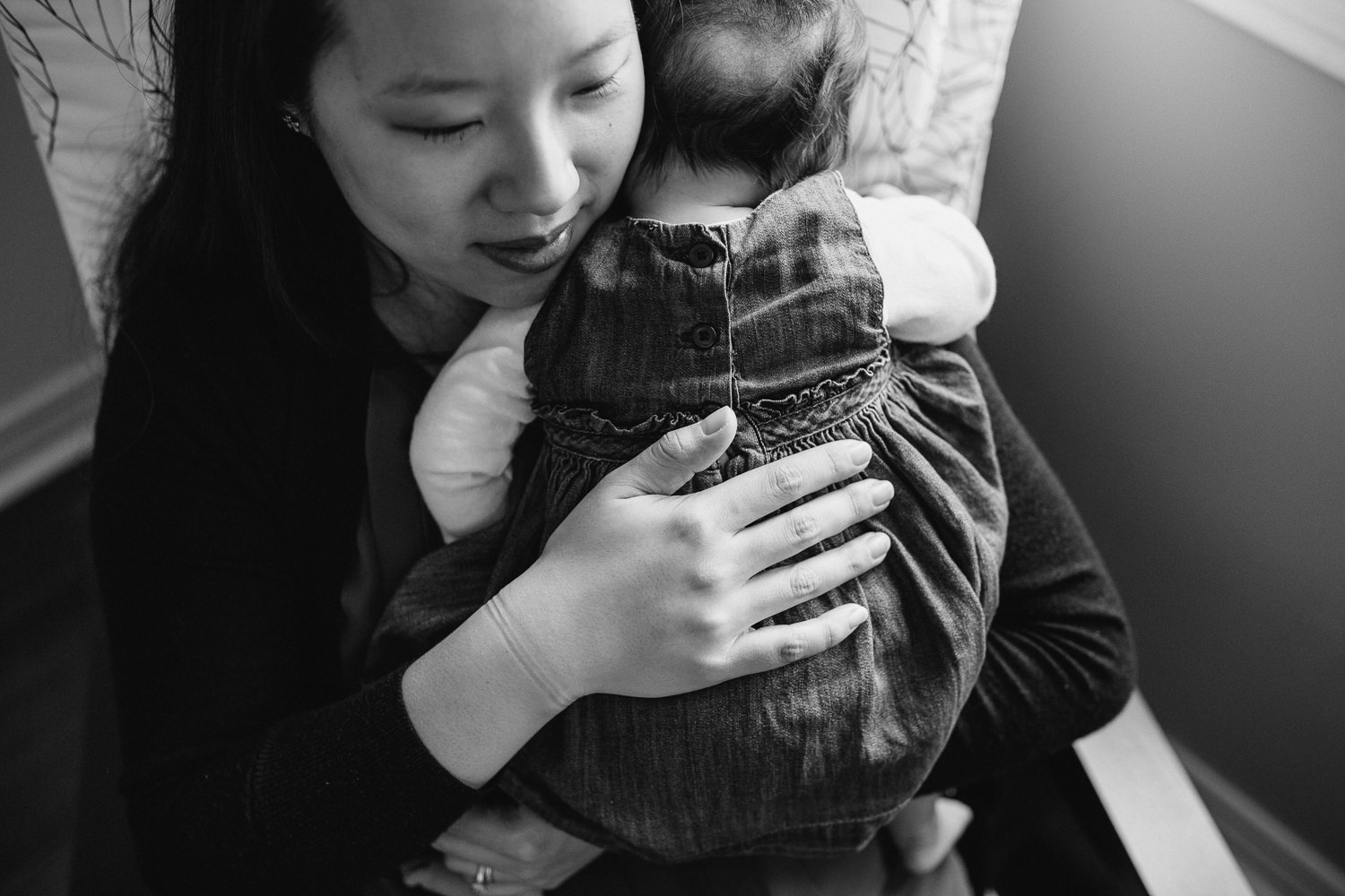 new mom snuggles 2 month old baby daughter to chest - Markham In-Home Photography