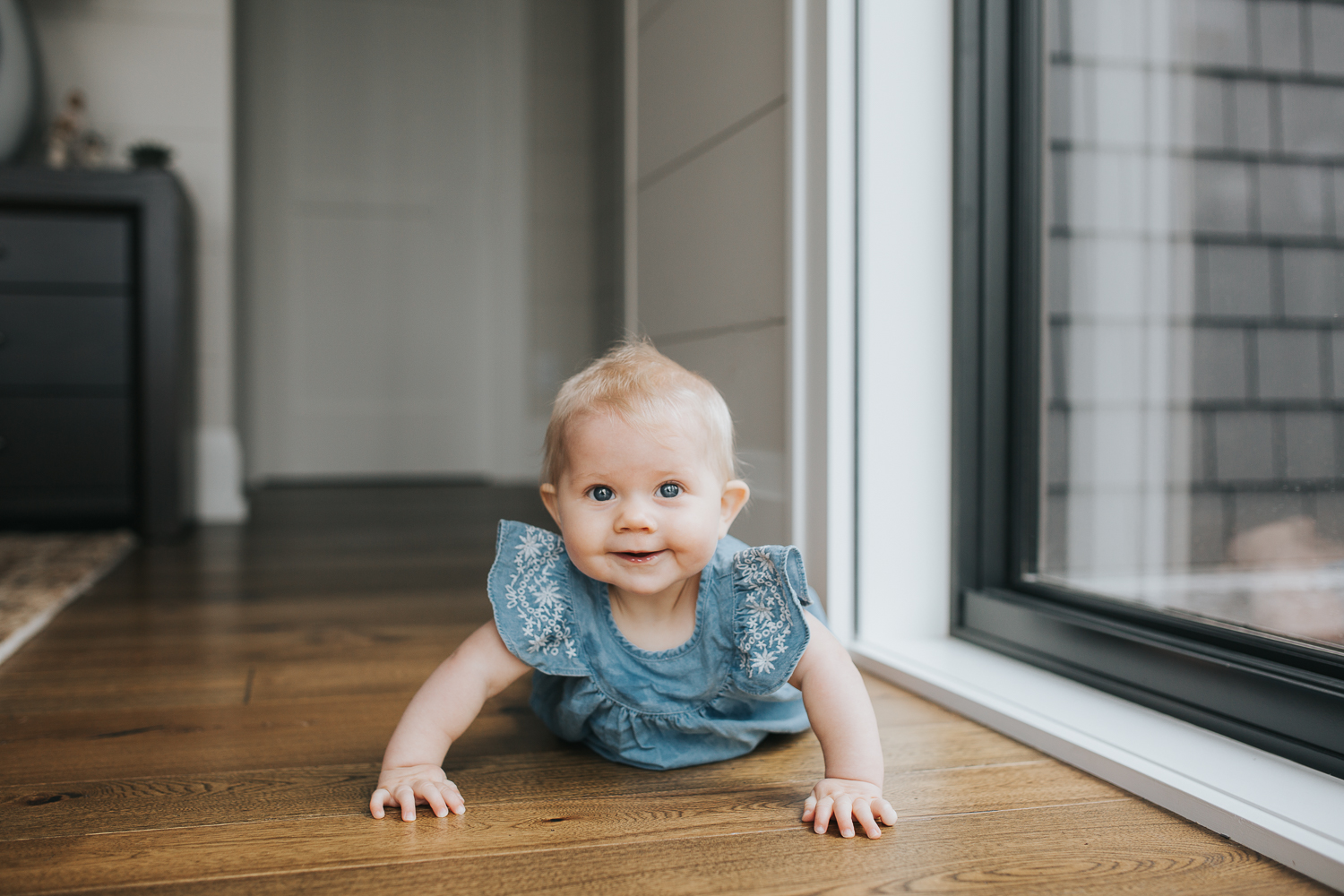 6 month old baby girl looking at camera, doing tummy time - Barrie Lifestyle Family Photography