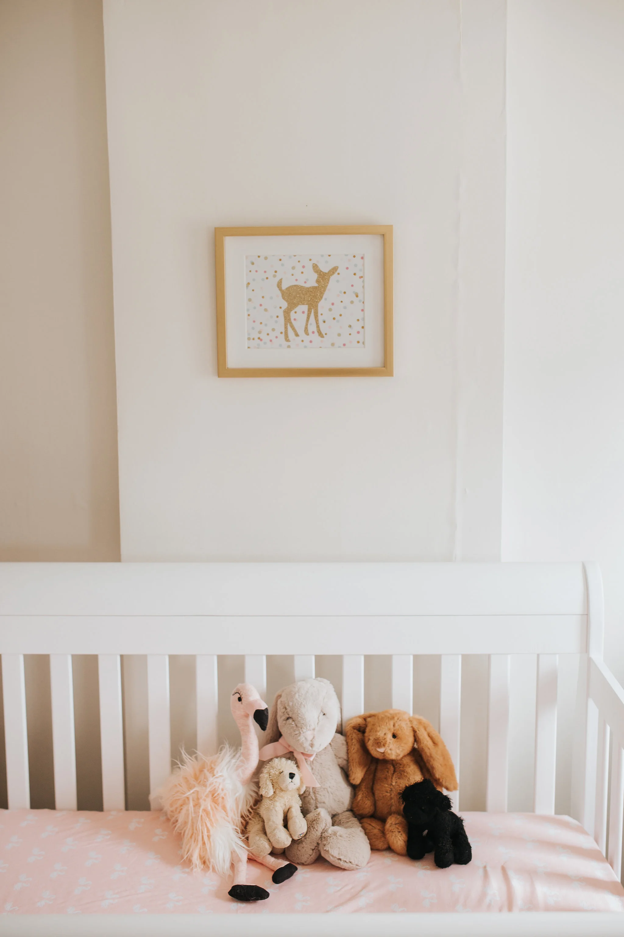 pink gold and white nursery details, stuffed animals in crib - Markham In-Home Photos
