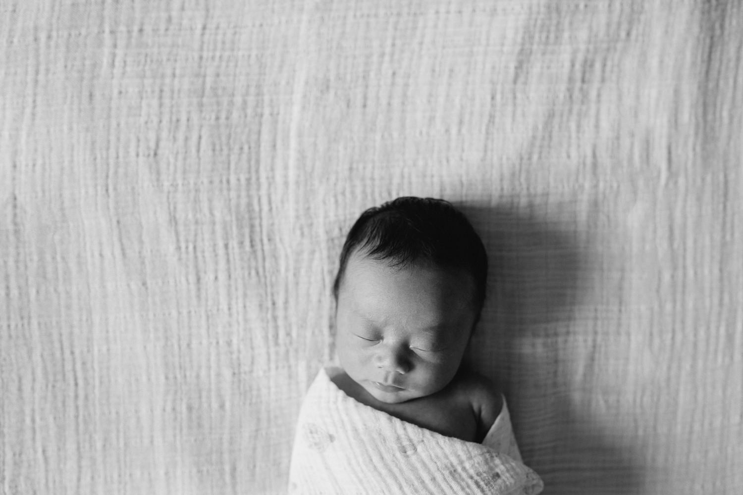 2 week old baby boy sleeping on bed in white swaddle - Stouffville Lifestyle Photography