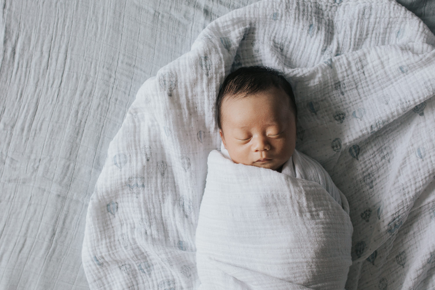 2 week old baby boy asleep in white swaddle - Stouffville Lifestyle Photography