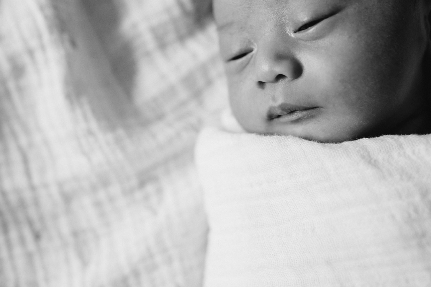 2 week old baby boy asleep in white swaddle - Barrie Lifestyle Photography