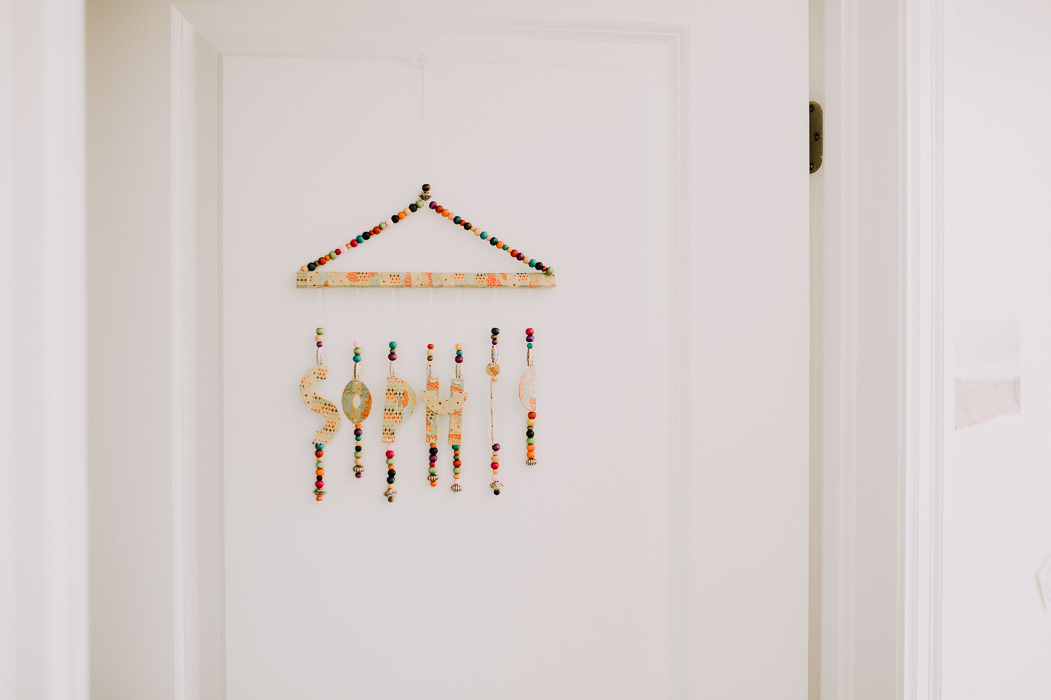 colourful beaded name decor hanging on nursery door - Stouffville In-Home Photos