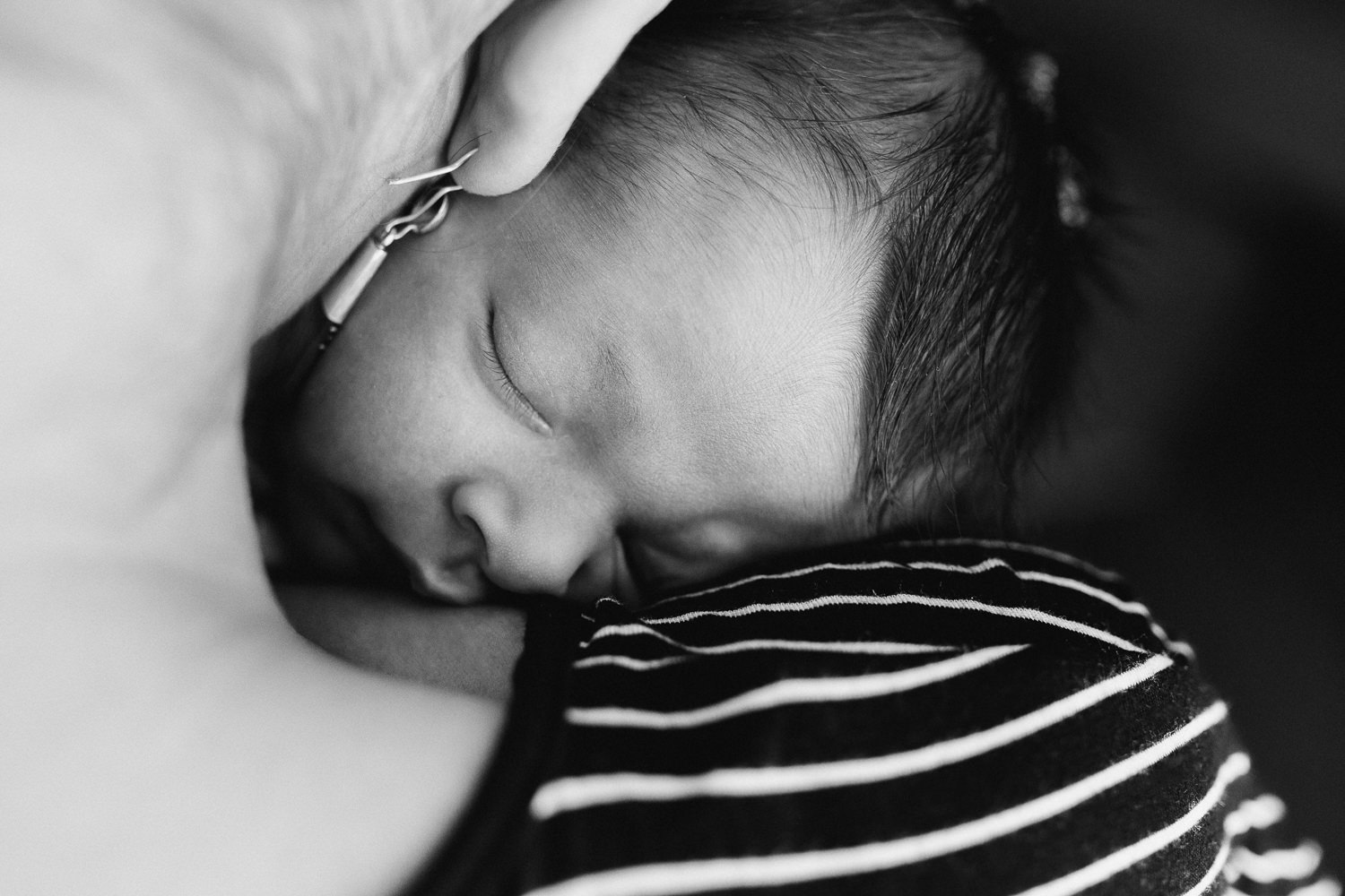 2 week old baby girl snuggled and asleep in her mother's neck - Newmarket In-Home Photography