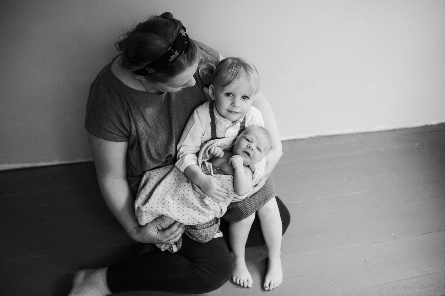 mother sits with toddler daughter and baby son in her arms - Stouffville Lifestyle Family Photography