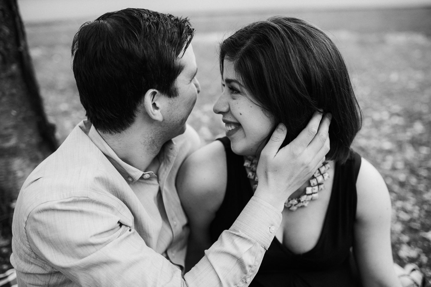 husband and pregnant wife sitting on a blanket in the park, woman looking at husband - Barrie Lifestyle Photos