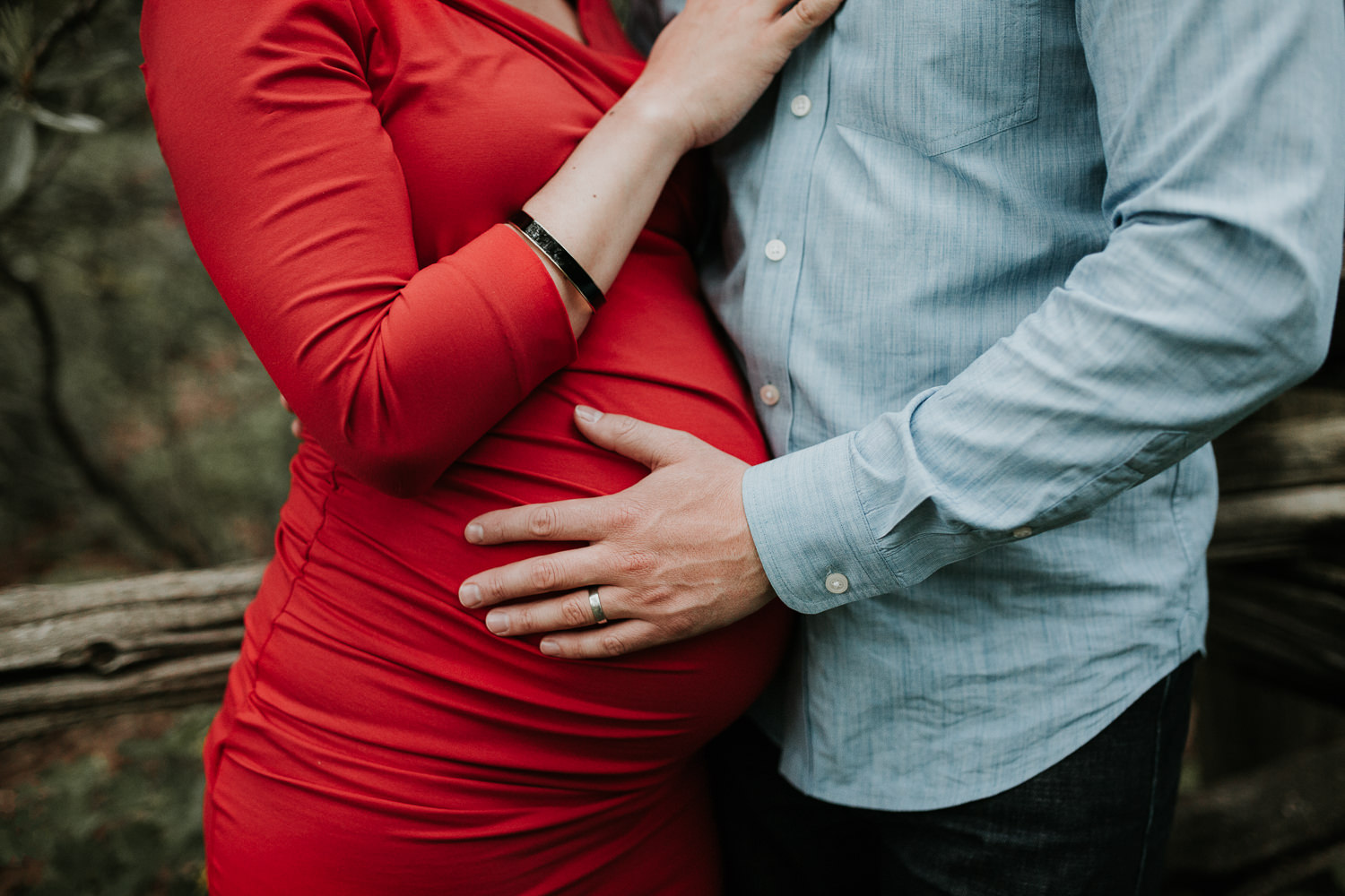 husband's hand on pregnant wife's baby bump - Markham Lifestyle Photography